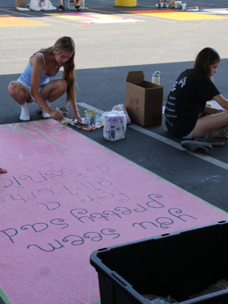 Seniors paint personalized parking spots